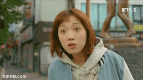 Surprised Woman In Front Of Statue And Netflix Logo GIF