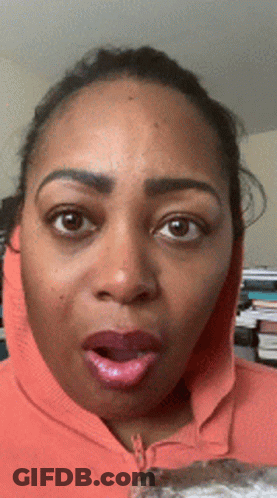 Surprised Woman In Orange Hoodie GIF