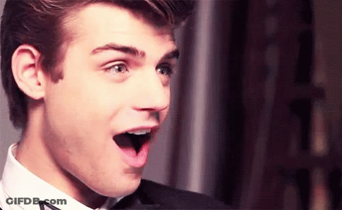 Surprised Young Man In Suit And Bow Tie GIF