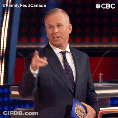 Survey Says Gerry Dee Pointing At Board GIF