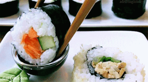 Sushi Plate With Chopsticks And Soy Sauce Drifting In Tokyo GIF