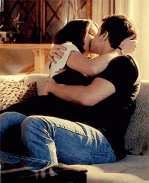 Sweet Couple Kissing In Couch GIF
