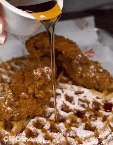Syrup Is Poured Over A Waffle With Powdered Sugar GIF
