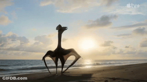 T-Rex And Baby T-Rex On Sandy Beach With Apple TV+ Logo GIF