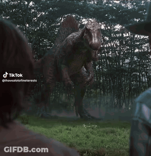 T-Rex Statue Standing In Grass GIF