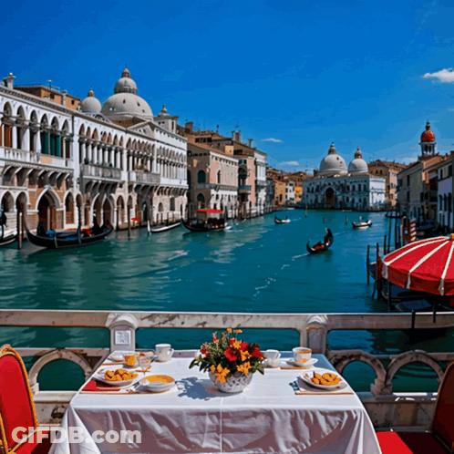 Table With Food And Flowers Overlooking Canal GIF