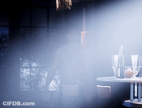 Table With Glasses And Bottle In Dark Room GIF