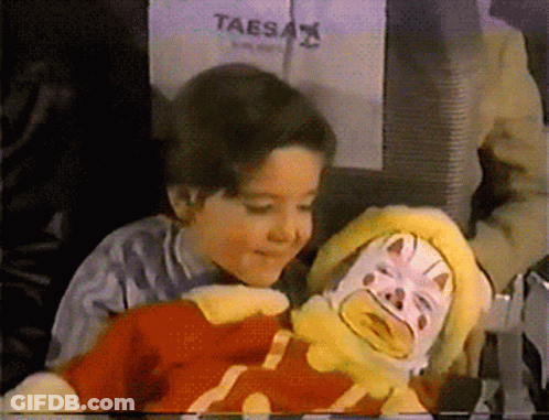 Taesa Sign Behind Child And Stuffed Clown GIF