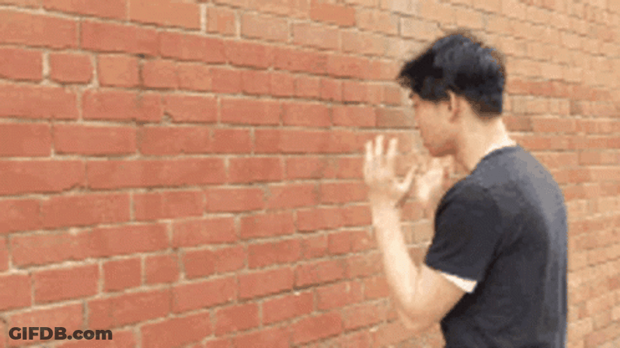 Talking To A Wall Asian Guy GIF