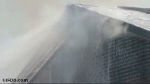 Tall Building With Smoke From Top GIF