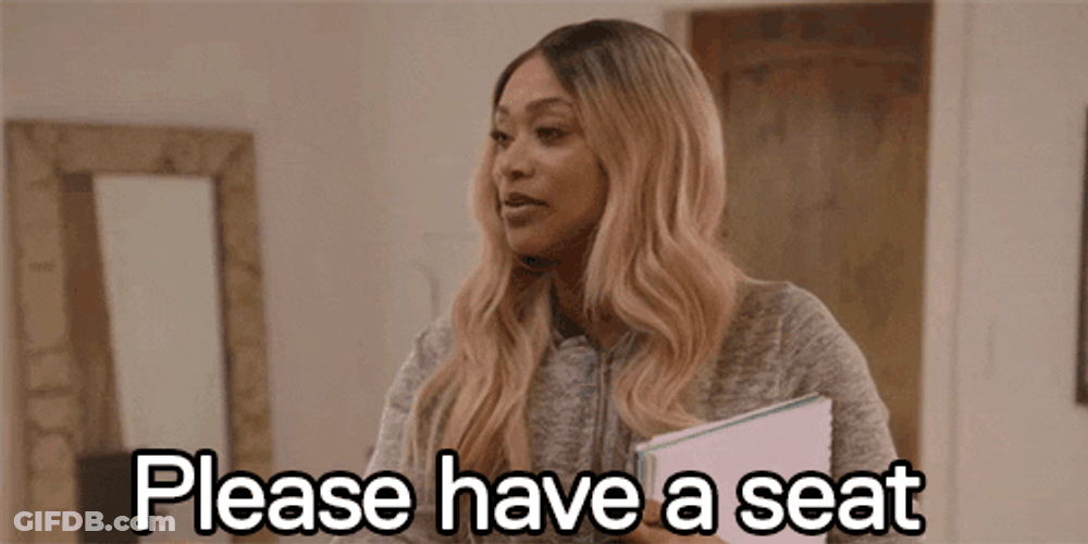 Tami Roman Inviting Guest To Sit Down GIF
