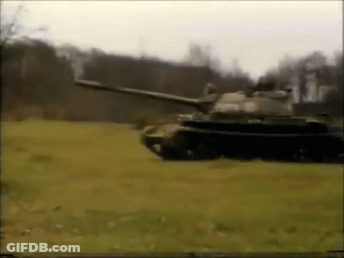 Tank Driving Through Field With Trees GIF