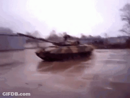 Tank Driving Through Flooded Parking Lot GIF