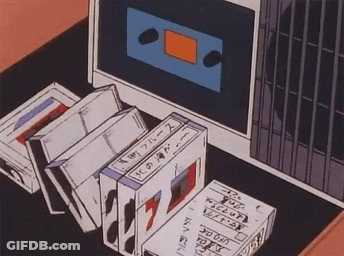 Tapes Sitting On Table Next To Computer GIF