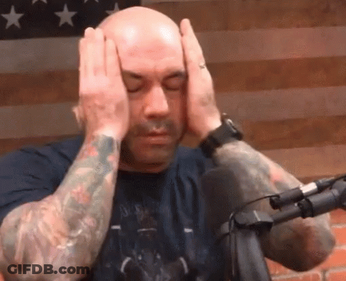 Tattooed Man Covering Head At Microphone GIF