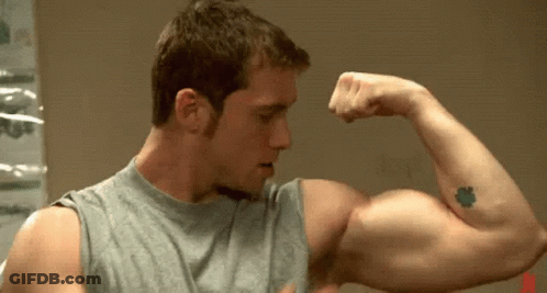 Tattooed Man Flexing Arm GIF
