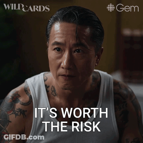 Tattooed Man In White Tank Top Says It's Worth The Risk GIF