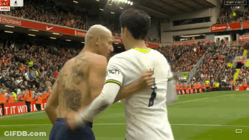 Tattooed Man Shaking Hands On Soccer Field GIF
