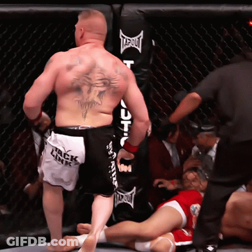 Tattooed Man Standing Before Punching Bag GIF