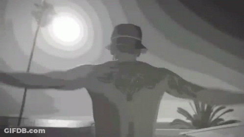 Tattooed Man Standing With Arms Out GIF