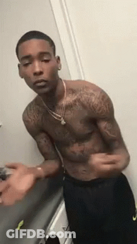 Tattooed Shirtless Man In Mirror GIF