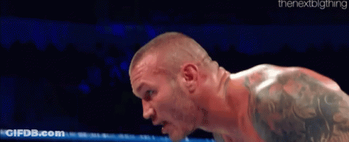 Tattooed Shirtless Wrestler Standing In Ring GIF