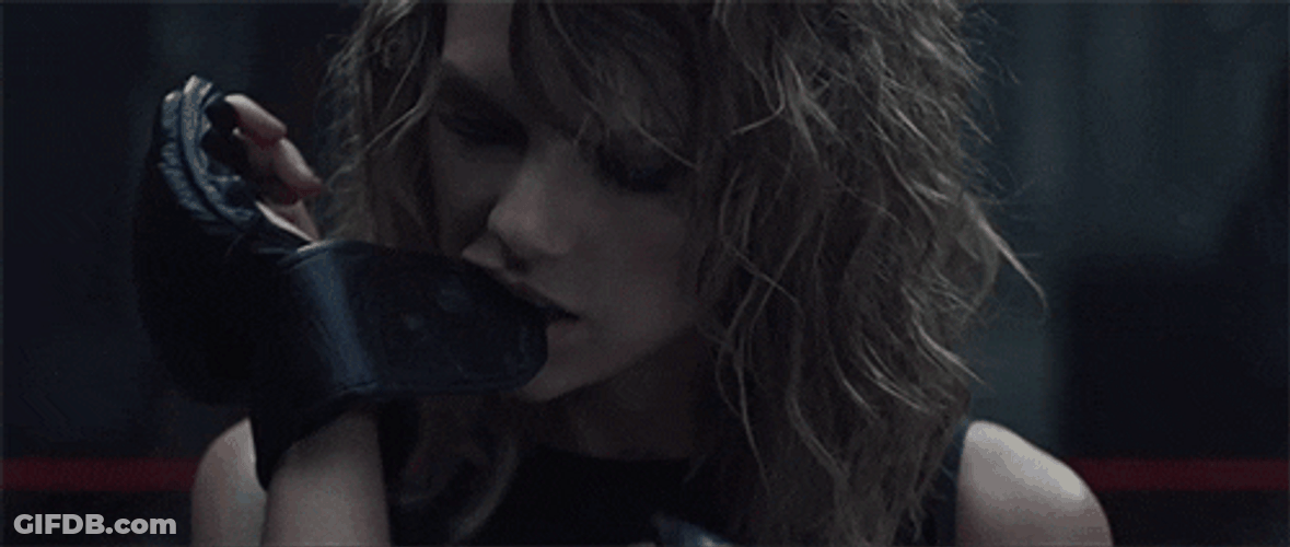 Taylor Swift Bites Gloves GIF