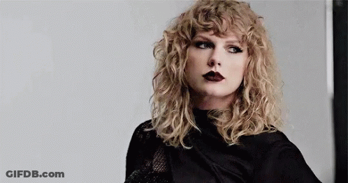 Taylor Swift In Black Shirt And Black Lipstick With Curly Hair GIF