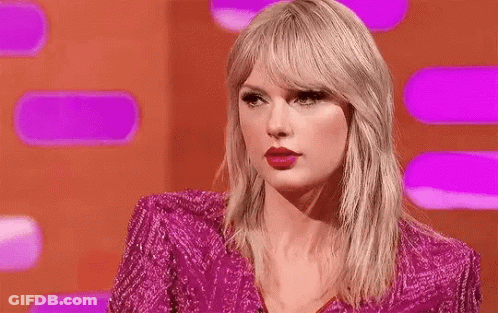 Taylor Swift In Pink Dress Making Funny Face On Stage GIF