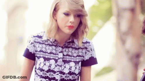 Taylor Swift In Purple White Floral Shirt With Man GIF