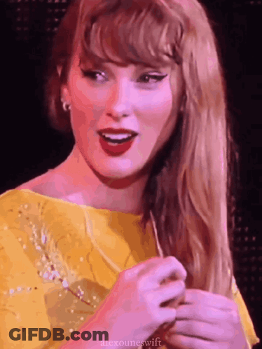 Taylor Swift In Yellow Dress Holding Hair GIF