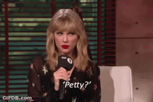 Taylor Swift Is Sitting In Front Of A Microphone And Talking Into It . GIF