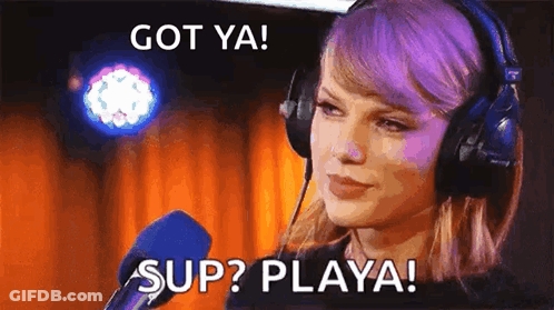 Taylor Swift Is Wearing Headphones And Talking Into A Microphone With The Words `` Got Ya ! Sup ? Playa ! '' GIF