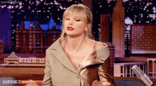 Taylor Swift Sitting At Microphone On Stage GIF