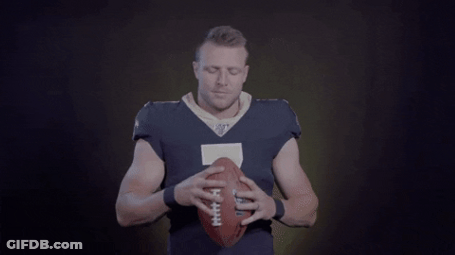 Taysom Hill Extending Hand Holding Football Forward GIF