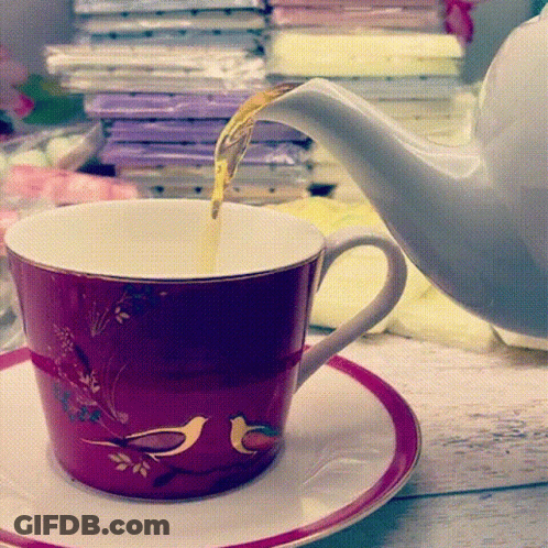 Tea Is Being Poured Into A Cup With Birds On It GIF