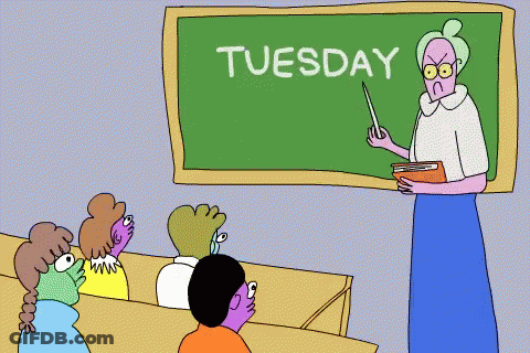 Teacher Standing In Front Of Tuesday Blackboard GIF