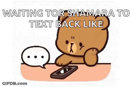 Teddy Bear At Table With Cell Phone And Speech Bubble GIF