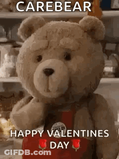 Teddy Bear In Red Apron Holding Rose GIF