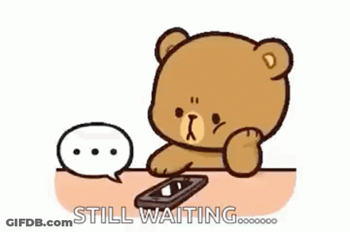 Teddy Bear Sitting At Table With Cell Phone And Speech Bubble GIF