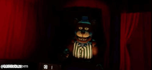 Teddy Bear Standing In Front Of Red Curtain GIF