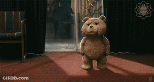 Teddy Bear Standing On Red Carpet In Front Of Window With Apple Logo GIF