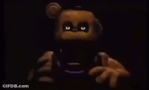 Teddy Bear With Glowing Eyes Holding Remote Control GIF