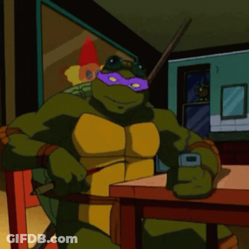 Teenage Mutant Ninja Turtle Sitting At Table With Cell Phone GIF