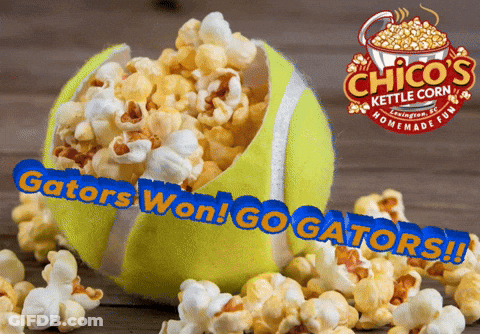 Tennis Ball Filled With Popcorn Next To Chico's Kettle Corn Sign GIF