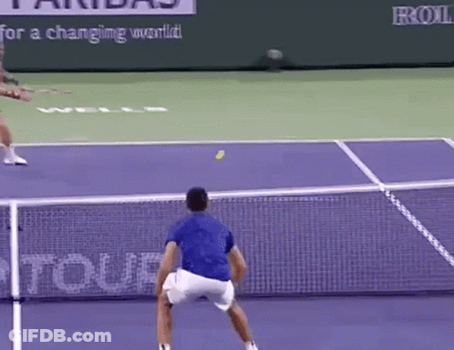 Tennis Player In Blue Shirt Serving Ball GIF