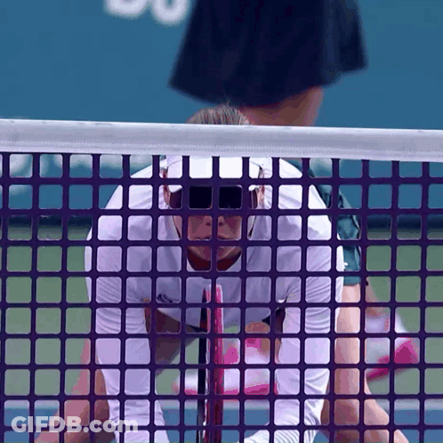 Tennis Player In Sunglasses Behind Purple Net GIF