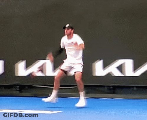 Tennis Player Jumping In Air On Blue Court GIF
