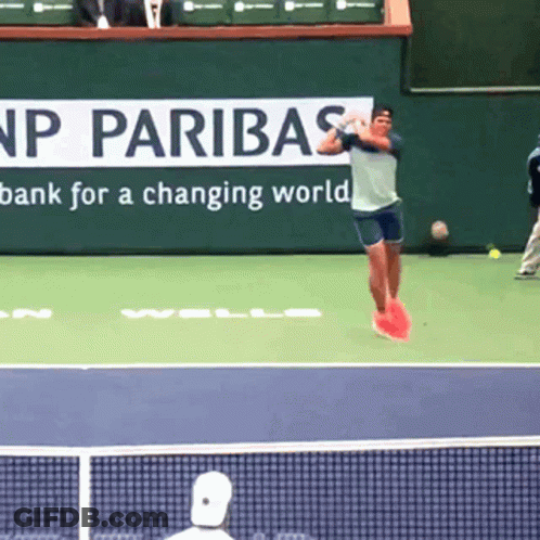 Tennis Player Jumping In Front Of Paribas Sign GIF