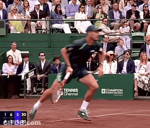 Tennis Player Running On Court In Front Of Tennis Channel Banner GIF